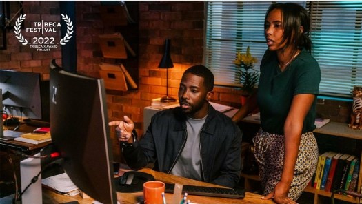 Dennis Pearson staring at a computer with Lowam Eyasu